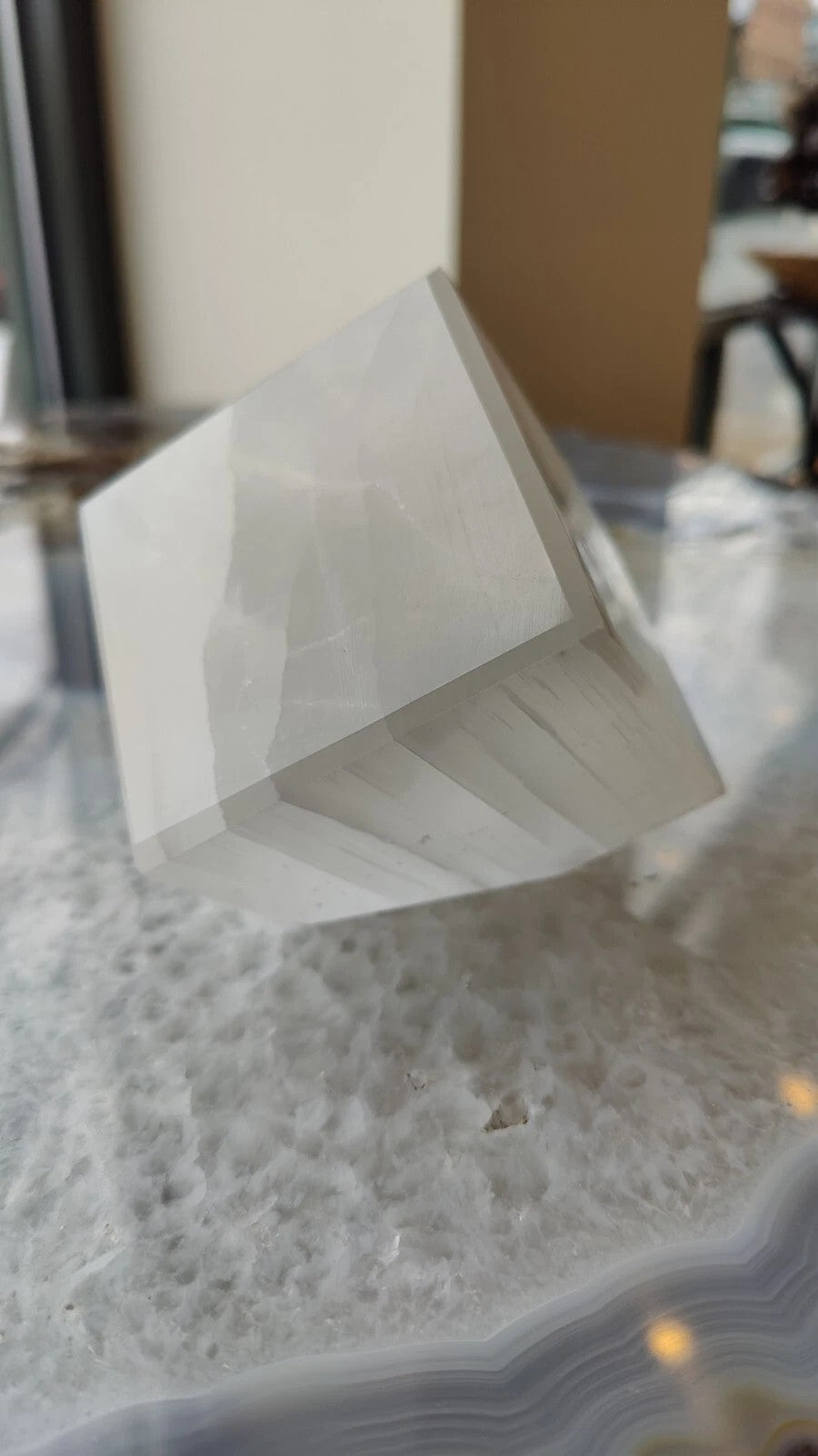 Translucent selenite standing cube, faceted white mineral block.