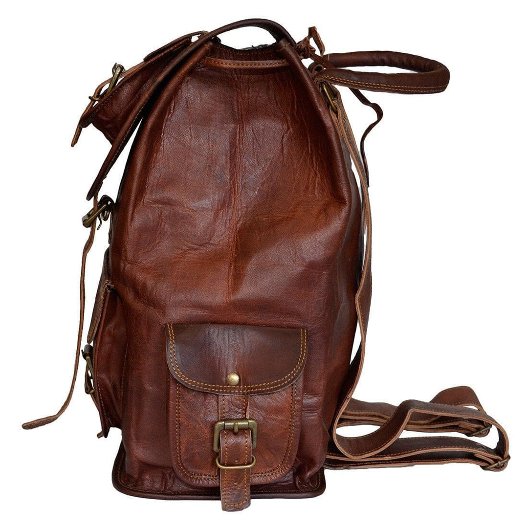 Dark brown leather drawstring backpack with front pocket, buckled flap and long strap.