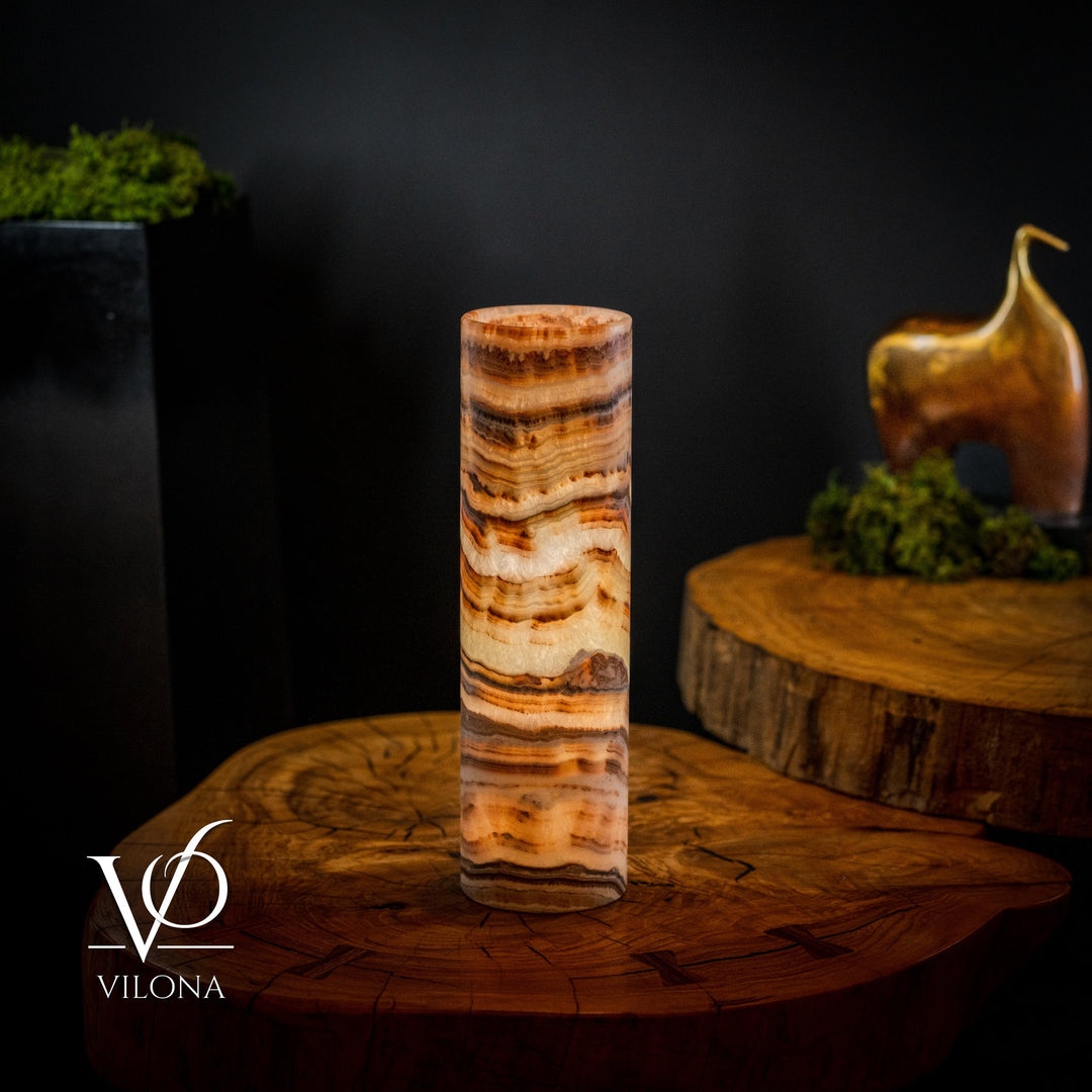 Cylindrical onyx crystal table lamp with glowing amber, cream, and tan stone bands