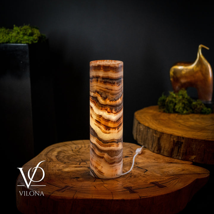 Cylindrical onyx crystal table lamp with dark brown top rim and amber-and-cream striations
