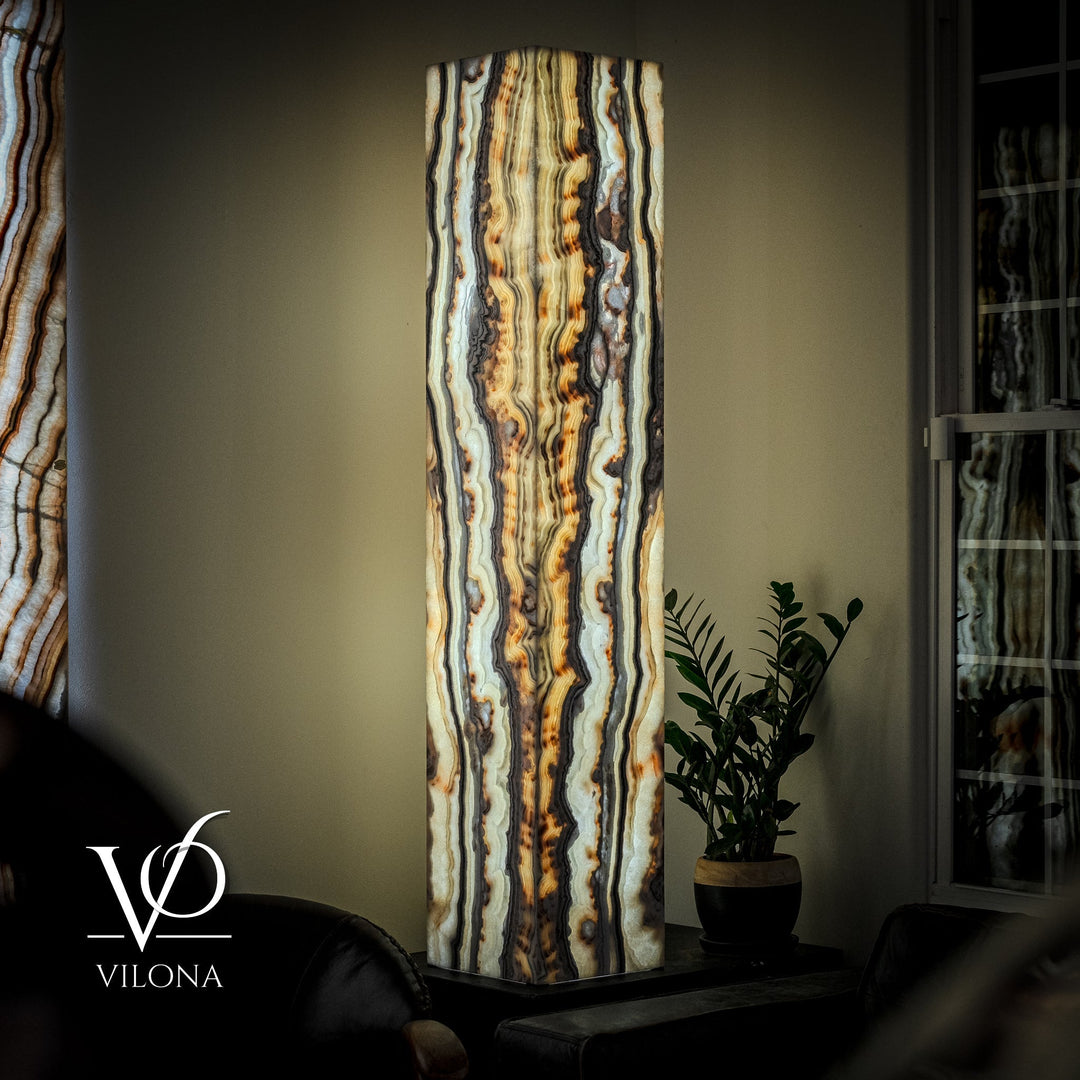 Large floor lamp with tall onyx panel shade, vertical cream, blue, and amber striations.