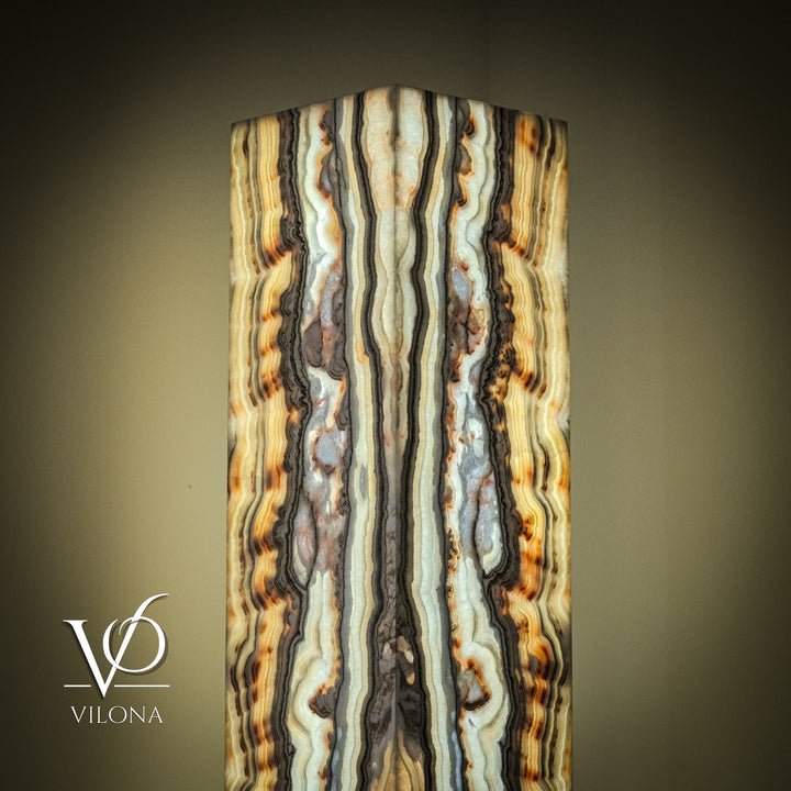 Square onyx floor lamp shade close-up with wavy vertical cream, blue, and amber bands.