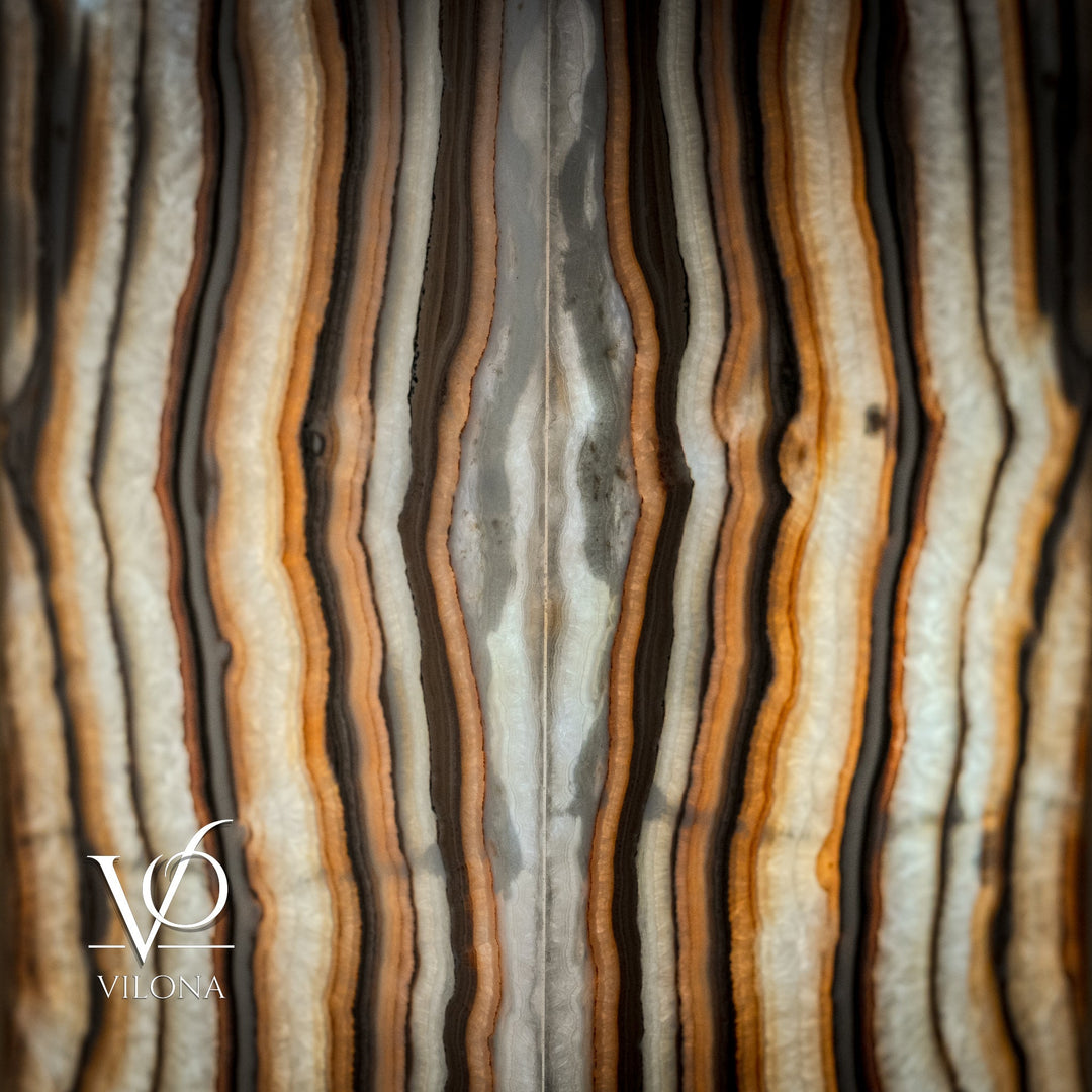 Close-up of onyx floor lamp shade with glossy cream, amber, and dark curving lines