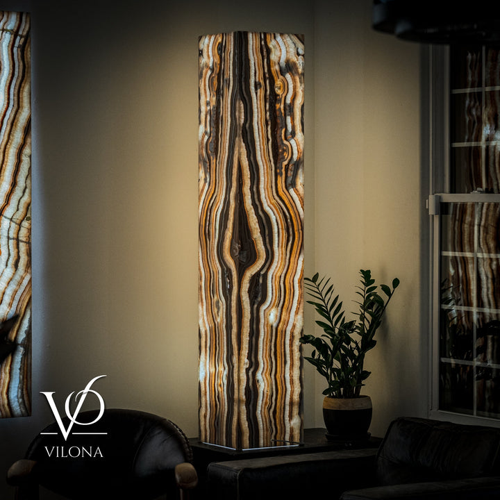 Large onyx floor lamp with tall rectangular stone shade and wavy cream, amber, and dark bands
