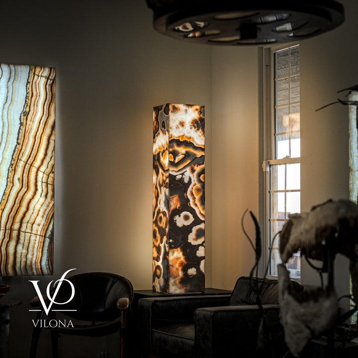 Polished onyx floor lamp with dark and amber marbled rectangular stone column and dark shade