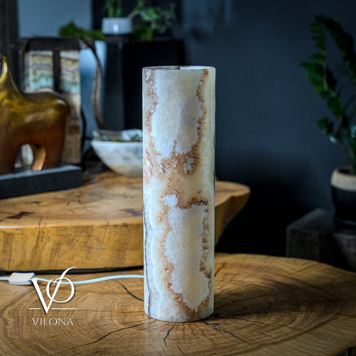 Cylindrical table lamp with light ivory onyx-style pattern and white power cord