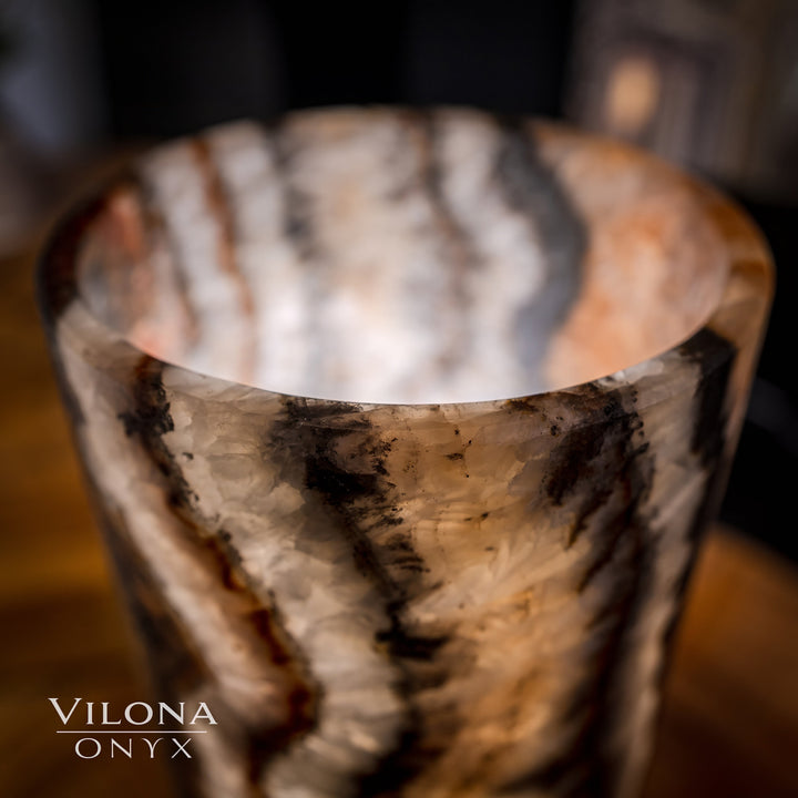 Onyx cylinder table lamp top view showing round rim and warm glowing interior.