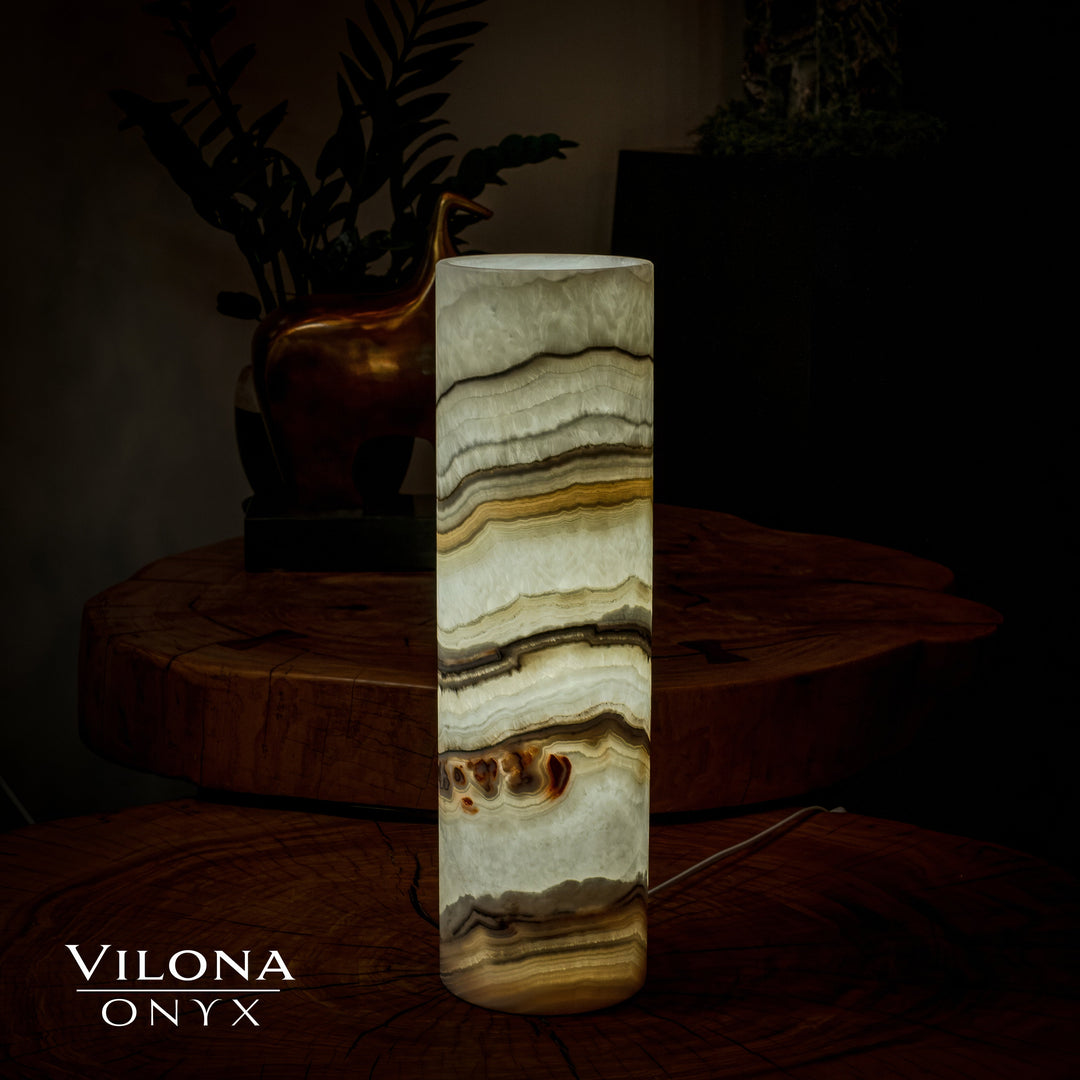Cream and gold onyx cylinder table lamp with layered wavy bands and polished base