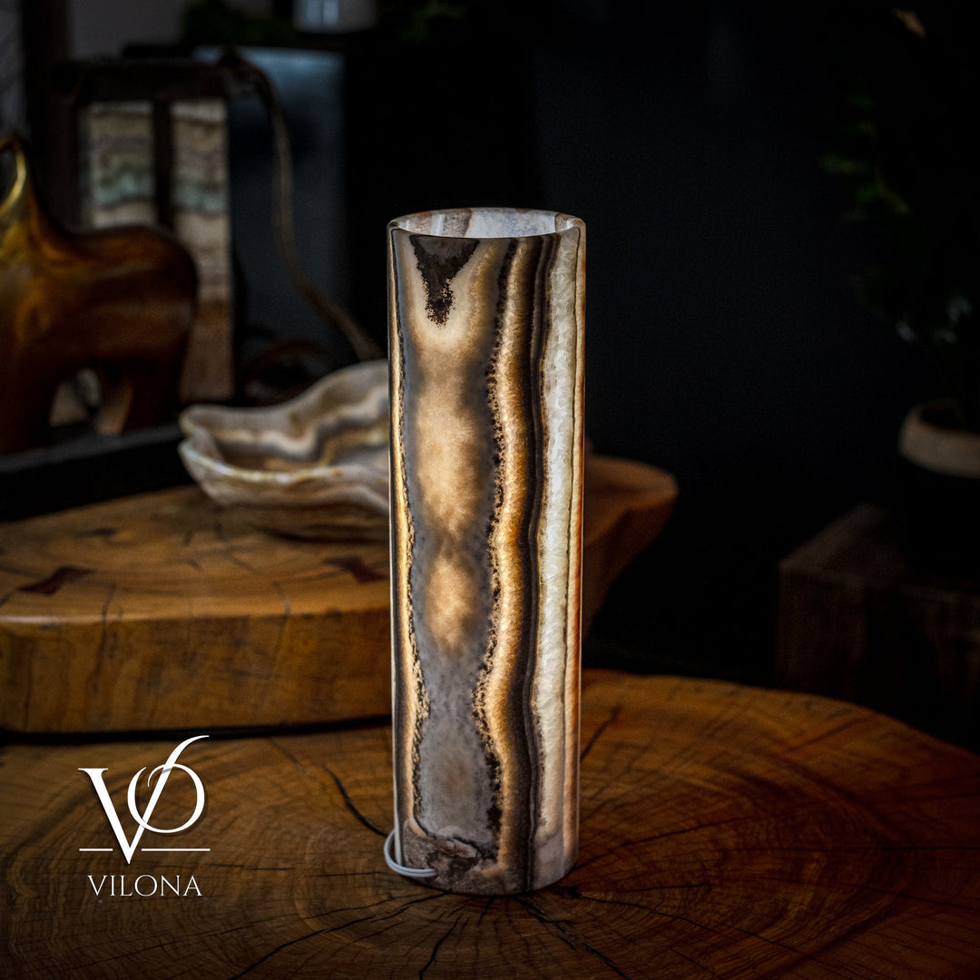 Cylinder table lamp with dark brown and gold marbled onyx texture on cream tones