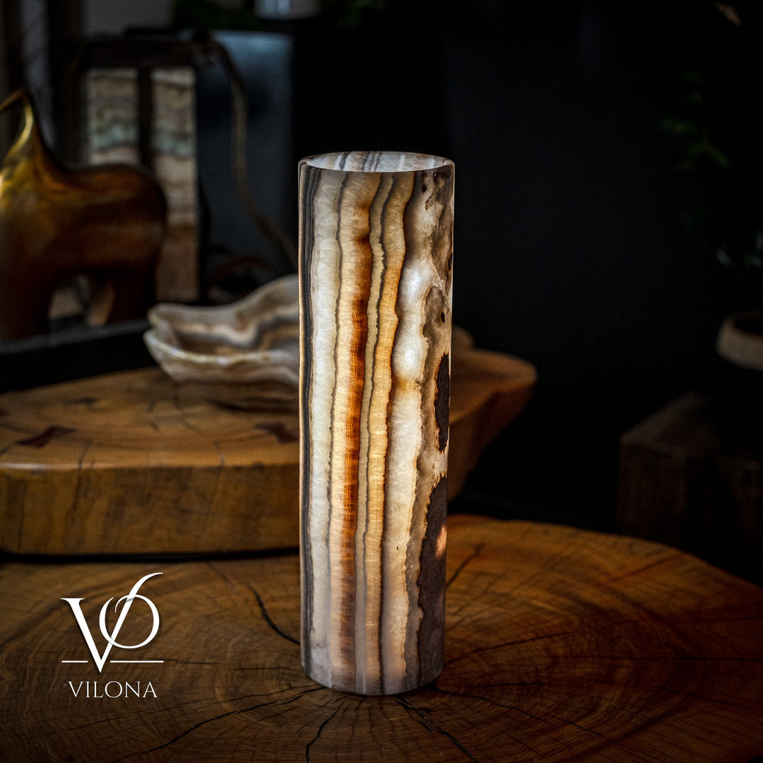 Cylinder table lamp with dramatic vertical amber-gold veining on dark brown stone