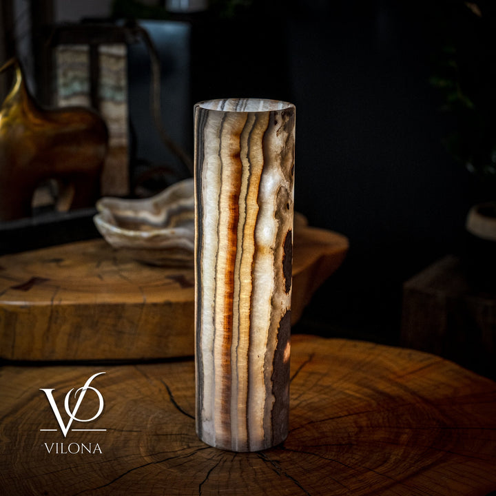 Cylinder table lamp with dramatic vertical amber-gold veining on dark brown stone