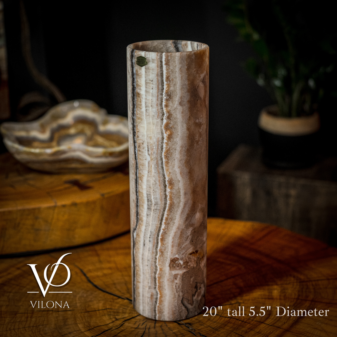 Cylinder table lamp with vertical light and dark striations and amber glow