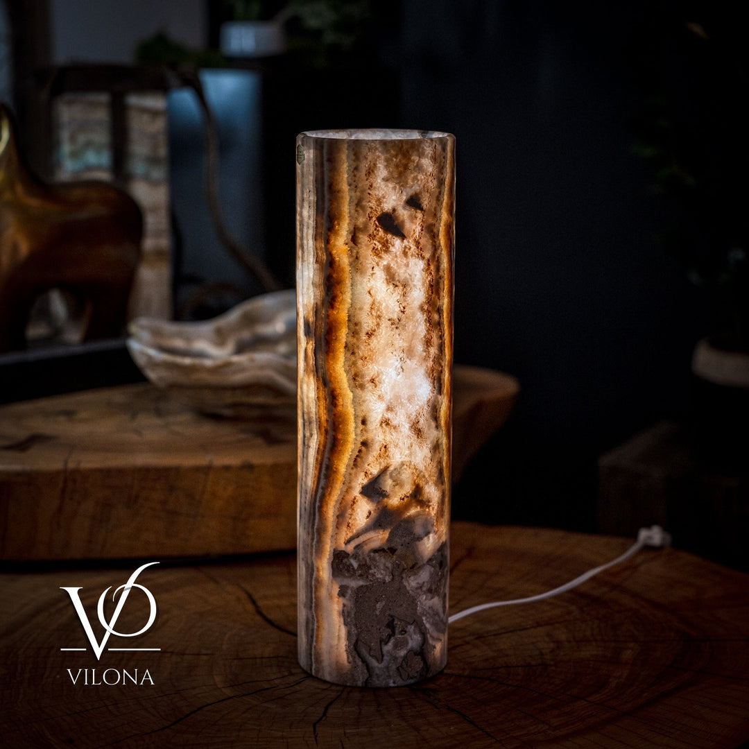 Cylinder table lamp with mottled stone surface and bright amber veining