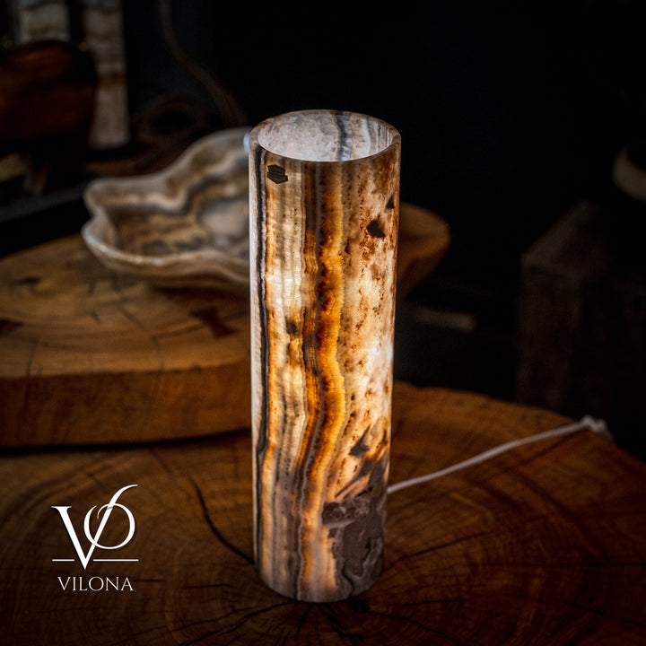 Cylinder table lamp with upright stone texture and dark amber swirl patterns