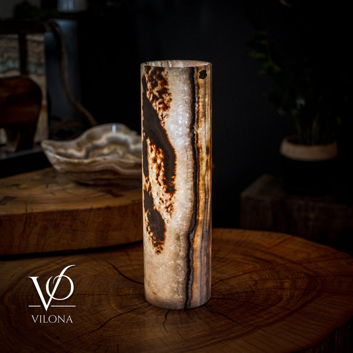 Cylinder table lamp with speckled stone finish and warm amber streaks