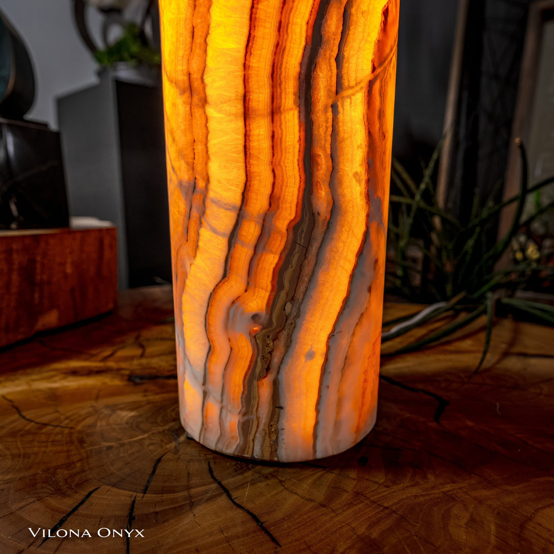 Cylinder table lamp lower detail with glowing amber onyx-look patterns