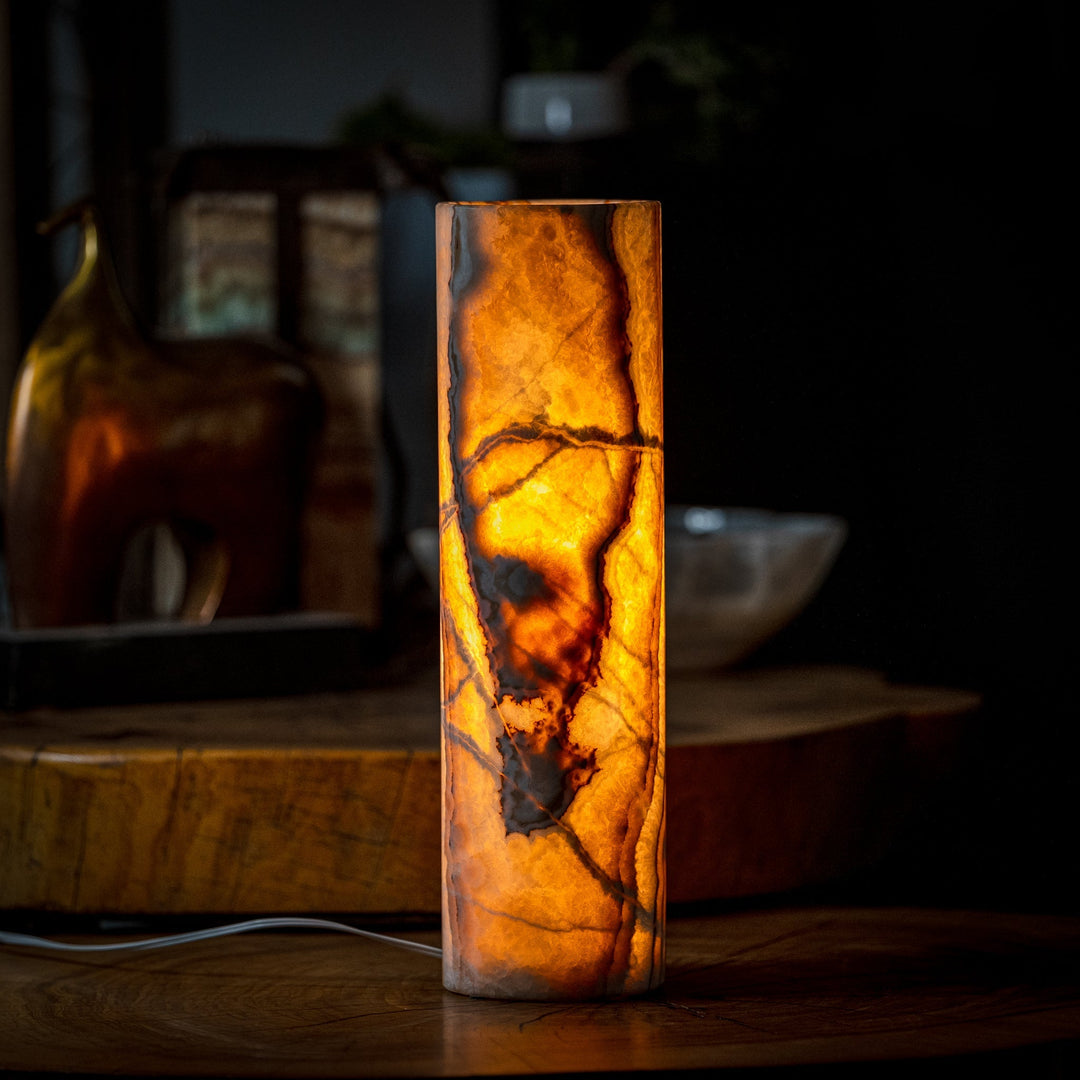 Cylinder table lamp with tall onyx-look cylinder and warm amber light inside