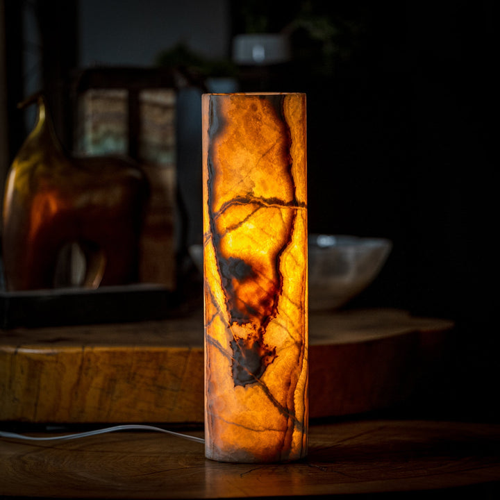 Cylinder table lamp with tall onyx-look cylinder and warm amber light inside