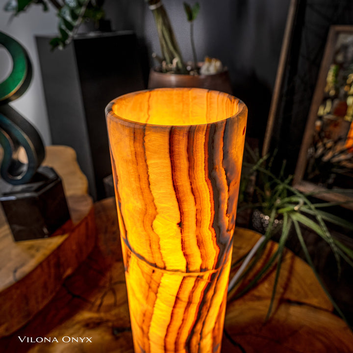 Cylinder table lamp close view: glowing amber onyx-look cylinder shade