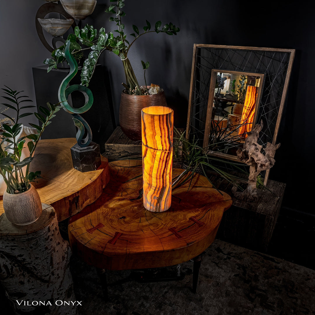 Cylinder table lamp with onyx-look vertical pattern and warm amber light
