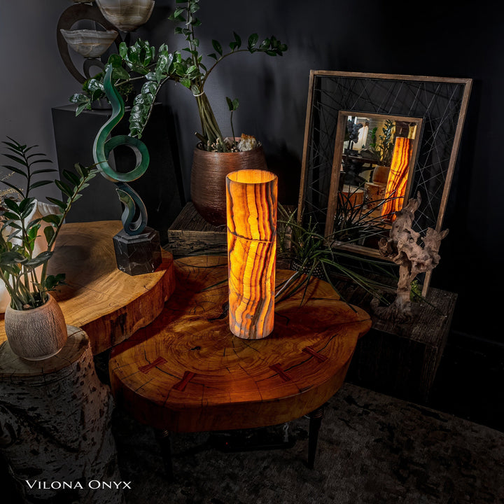 Cylinder table lamp with onyx-look vertical pattern and warm amber light