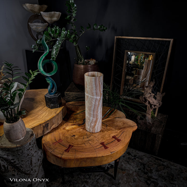 Cylindrical onyx table lamp on round wooden side table