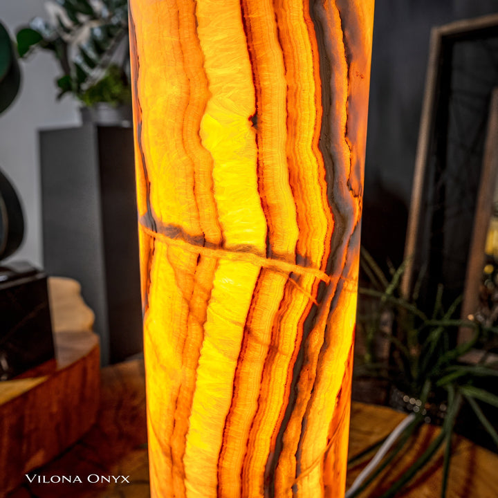 Cylinder table lamp detail: glowing amber onyx-look vertical bands