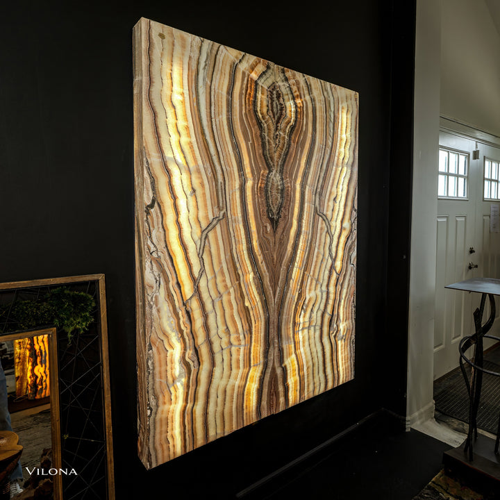 Onyx wall panel with tall golden stripes and branching dark vein pattern