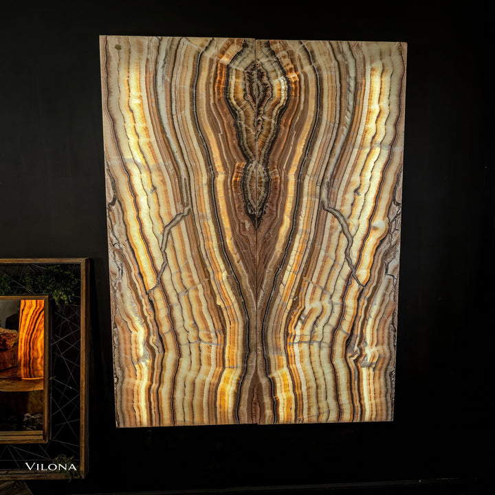 Large onyx wall panel with swirling light-gold lines and a dark center vein