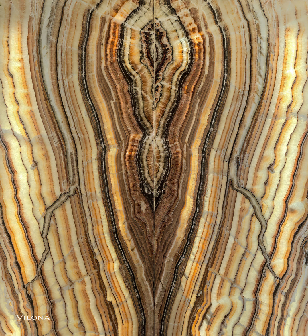 Onyx wall panel with vertical veining in cream, gold, and dark brown
