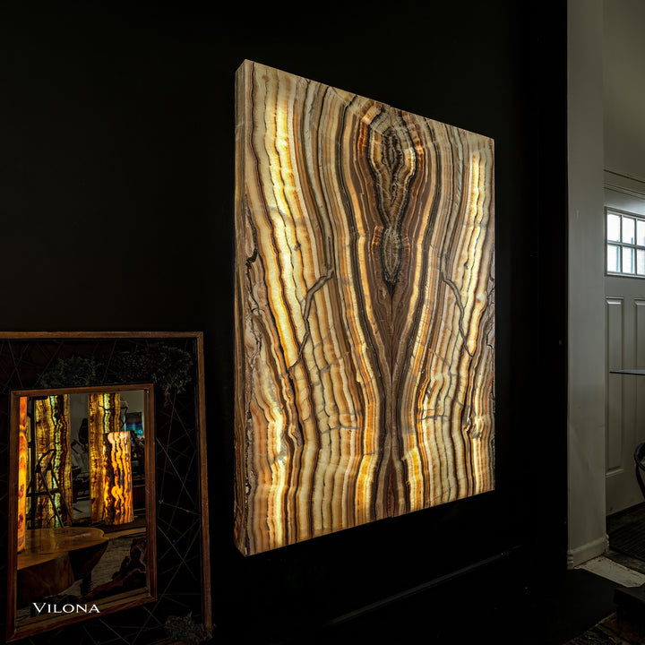 Onyx wall panel with vertical golden and dark veining on a rectangular board