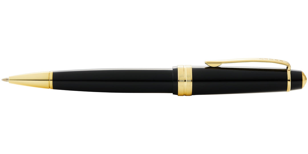 Black resin ballpoint pen with gold clip, banded grip, and pointed tip
