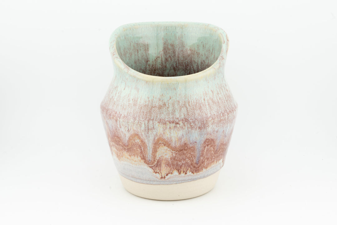 Ceramic dried flower sconce with side cutout, pink and blue speckled glaze, cream base