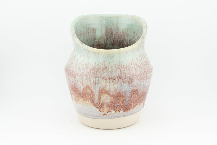Ceramic dried flower sconce with side cutout, pink and blue speckled glaze, cream base