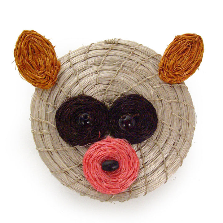 Small woven bear-shaped basket with black ears, orange arms, and pink nose.