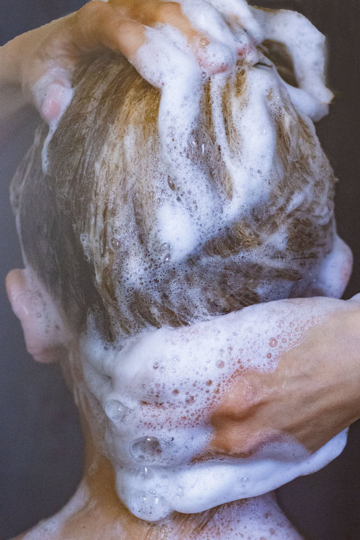 Shampoo bar lather on hands, thick white foam for washing