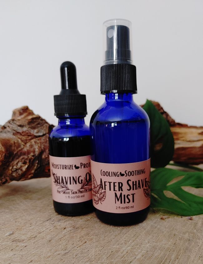 Two blue after shave mist bottles with spray caps and front labels