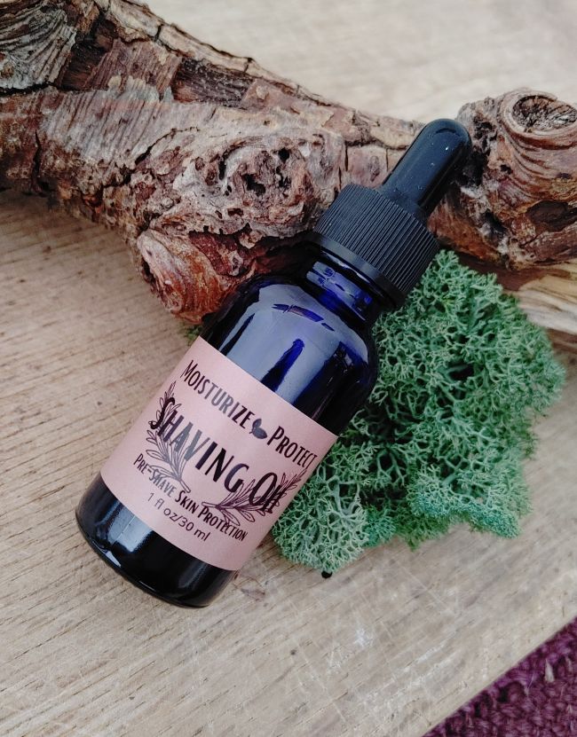 Blue shaving oil bottle with black dropper and plant-based skin care label