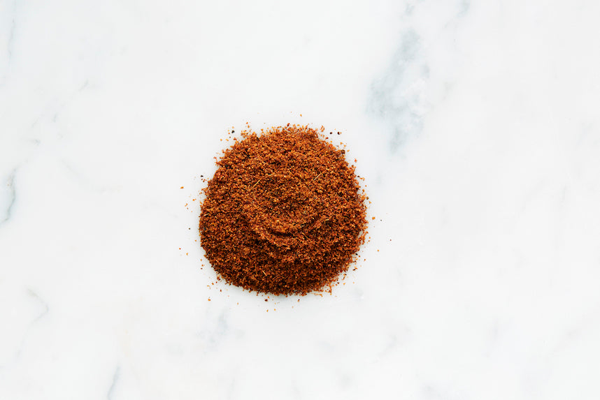 Heap of ground shawarma spice seasoning on a light surface