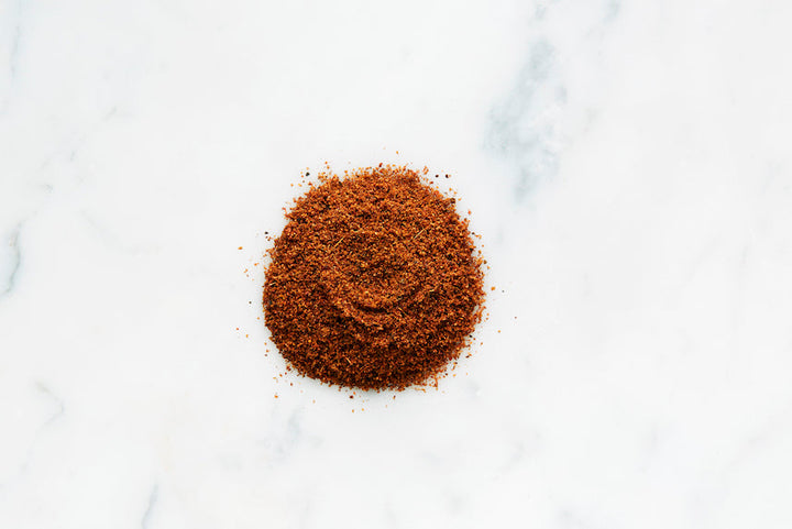 Heap of ground shawarma spice seasoning on a light surface