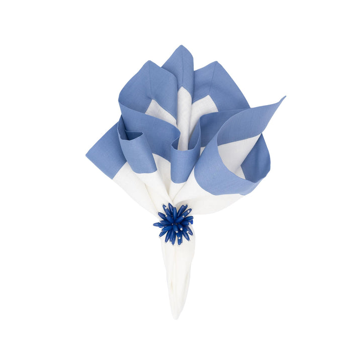 Folded linen napkins arranged with sky-blue and white stripes, tied with a blue flower