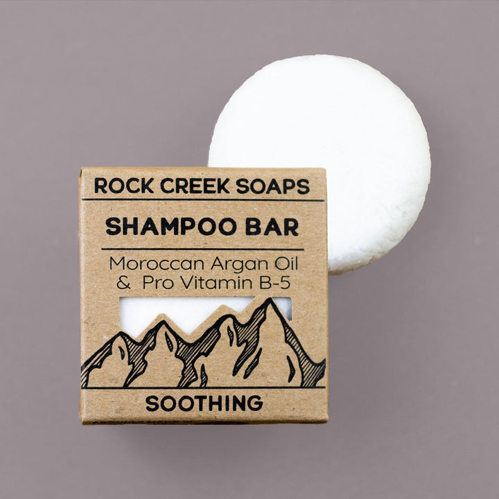 Soothing shampoo bar with cardboard box; white round bar