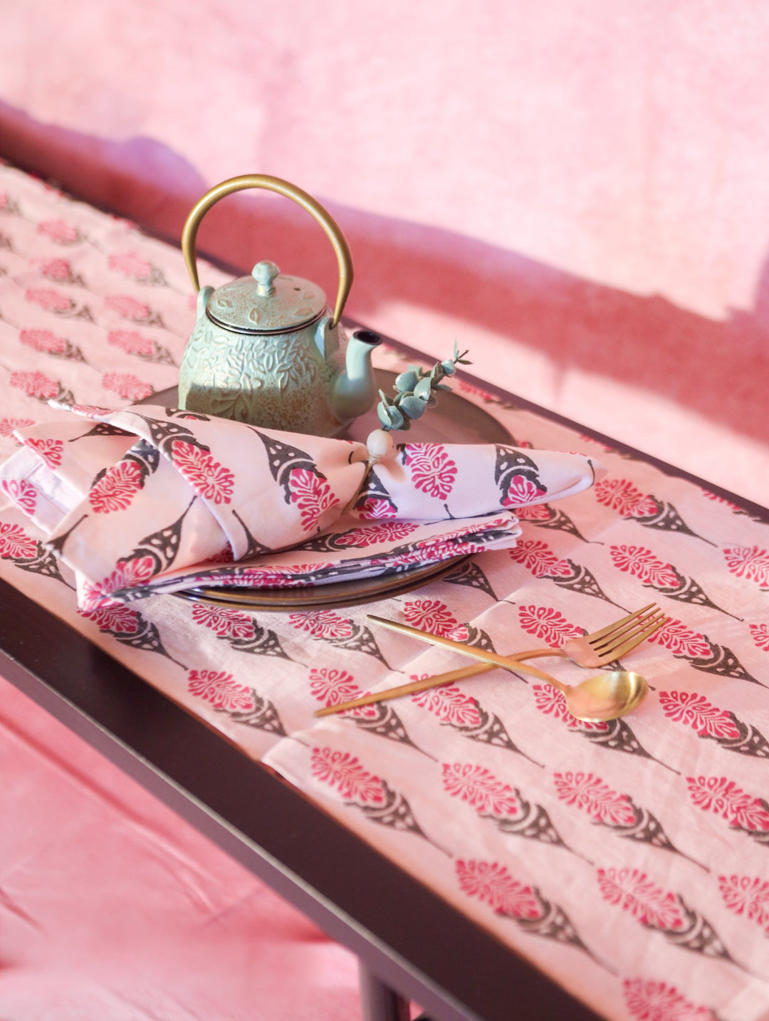 Bahaar hand-printed table runner, pink with repeating floral leaf pattern
