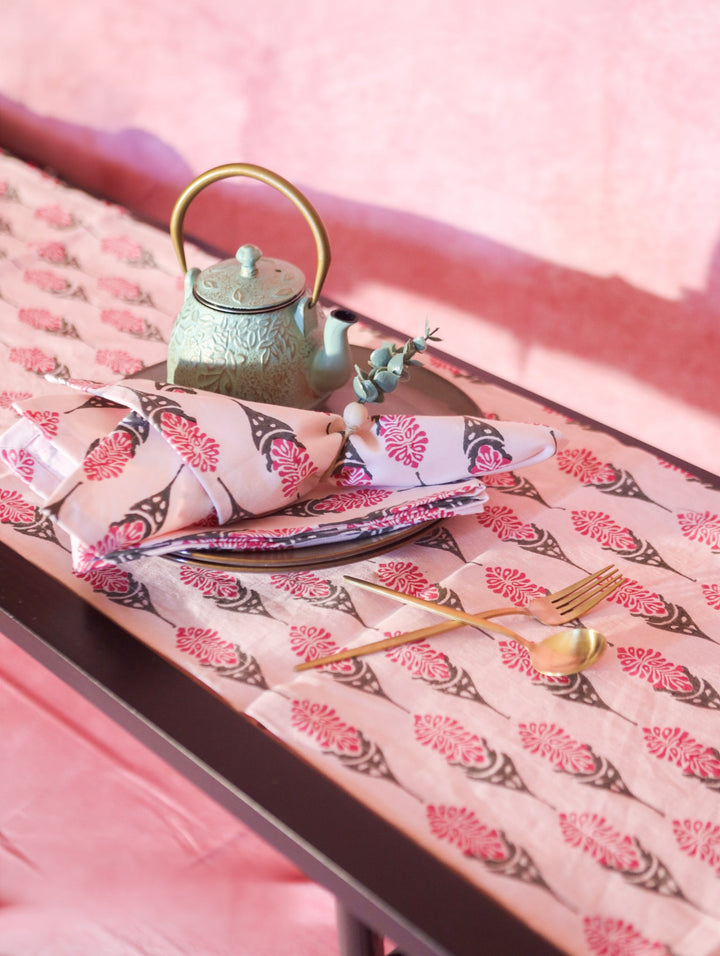 Bahaar hand-printed table runner, pink with repeating floral leaf pattern