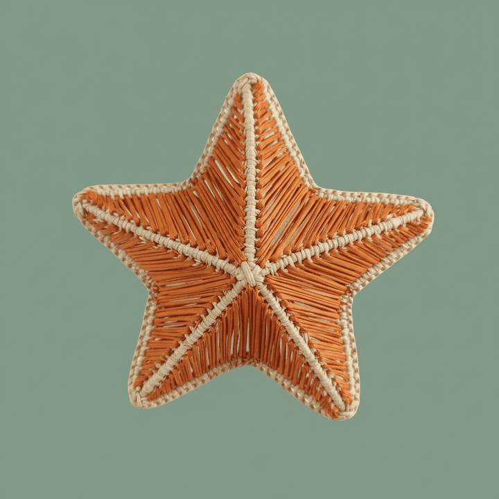 Starfish handwoven napkin ring with blush pink center and natural woven accents