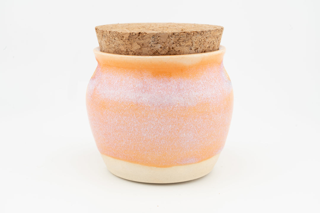 Corked 6 oz jar with speckled orange glaze and cream base