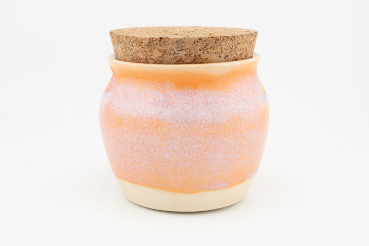 Corked 6 oz jar with speckled orange glaze and cream base