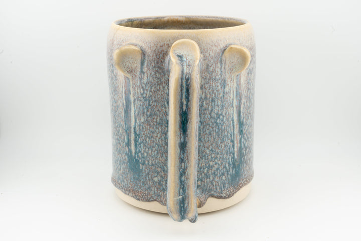 Blue ceramic stein mug with speckled glaze and vertical drip stripe pattern