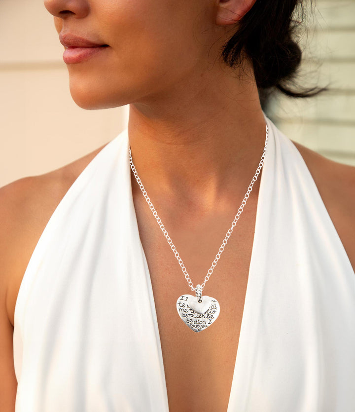 Sterling silver engraved heart pendant necklace on a model with fine chain