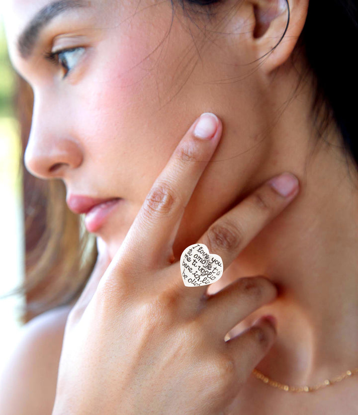 Heart statement ring in sterling silver, engraved text visible on finger